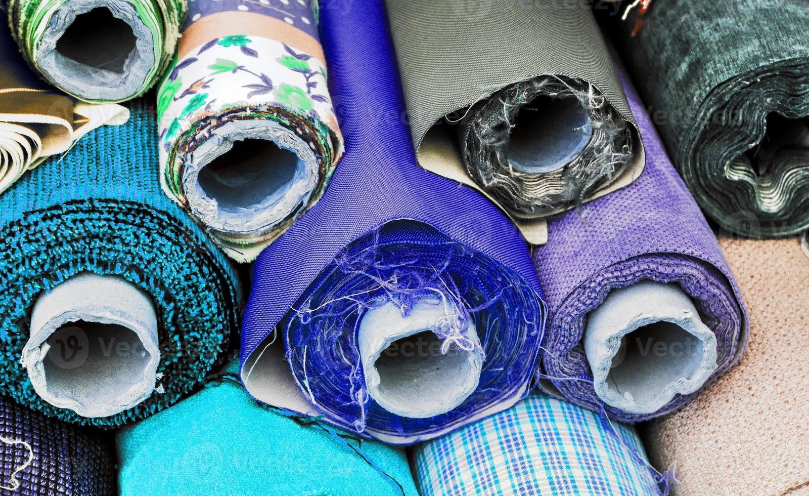 Detailed close up view on samples of cloth and fabrics in different colors found at a fabrics market photo