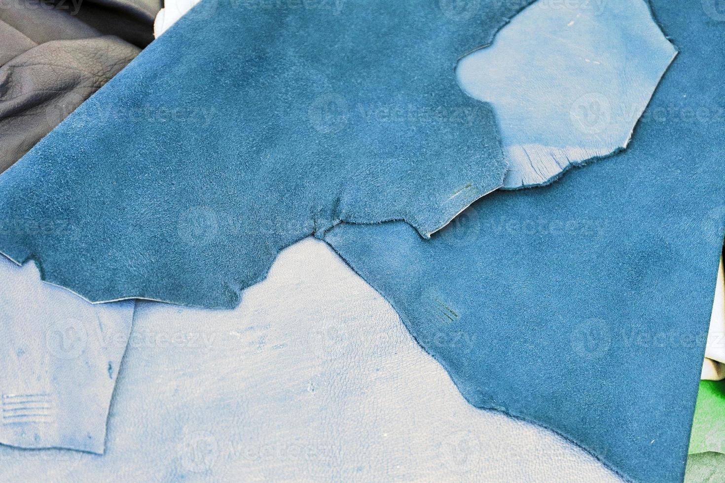 Detailed close up view on samples of cloth and fabrics in different colors found at a fabrics market photo