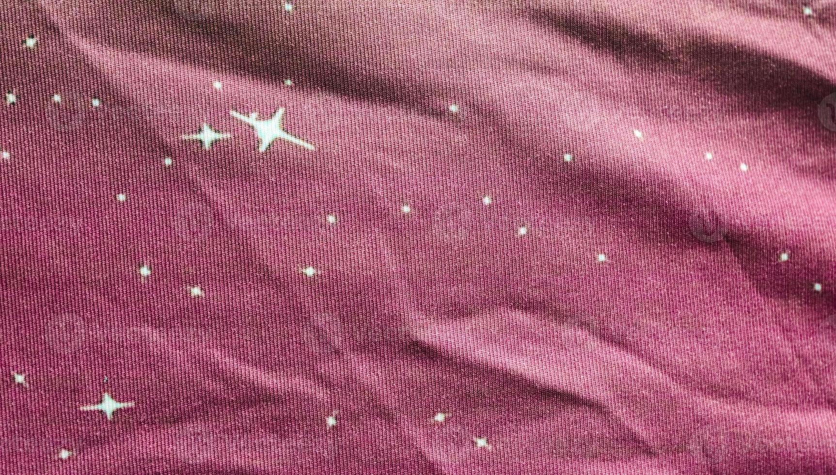 Detailed close up view on samples of cloth and fabrics in different colors found at a fabrics market photo