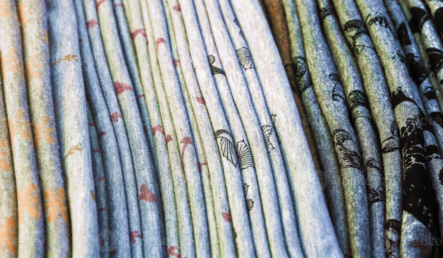 vista detallada de las muestras de telas y tejidos de diferentes colores que se encuentran en un mercado de tejidos foto