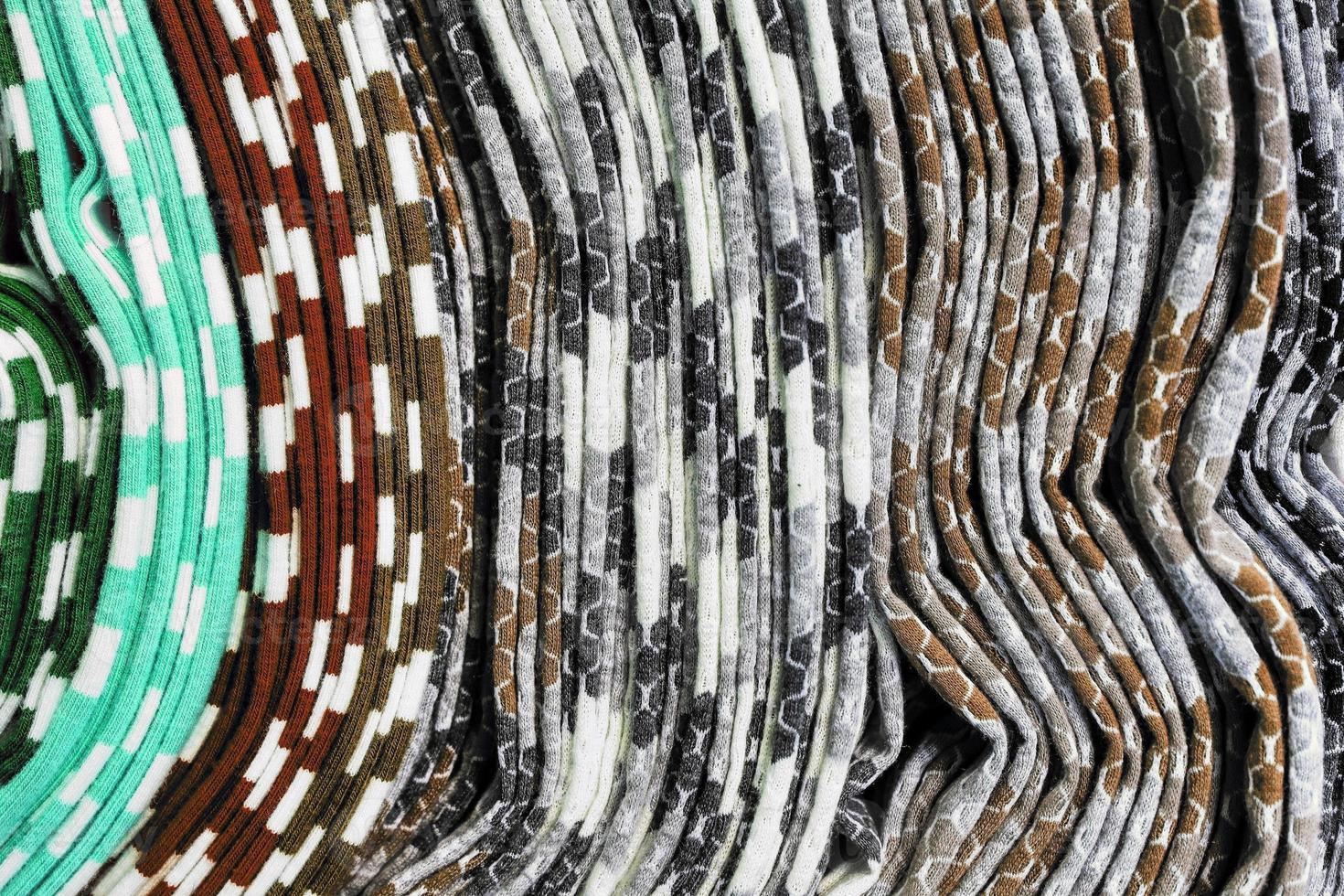 Detailed close up view on samples of cloth and fabrics in different colors found at a fabrics market photo