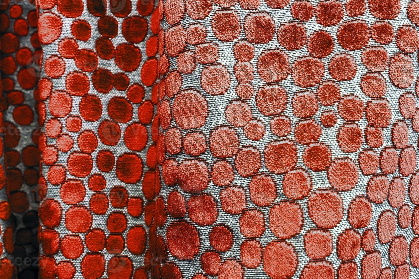 Detailed close up view on samples of cloth and fabrics in different colors found at a fabrics market photo