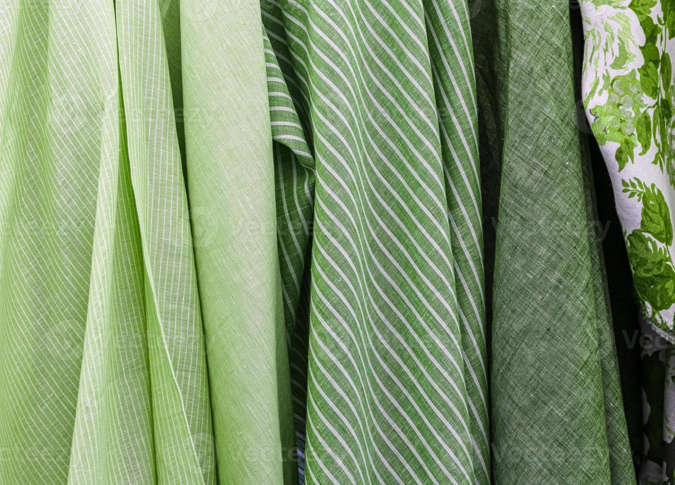 Detailed close up view on samples of cloth and fabrics in different colors found at a fabrics market photo