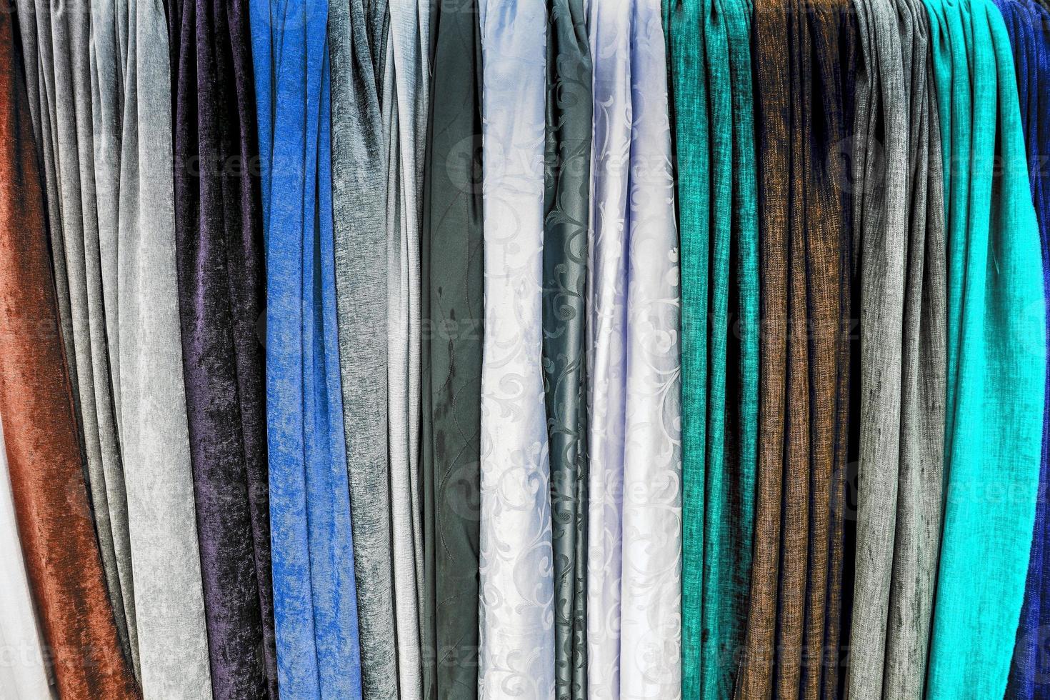Detailed close up view on samples of cloth and fabrics in different colors found at a fabrics market photo
