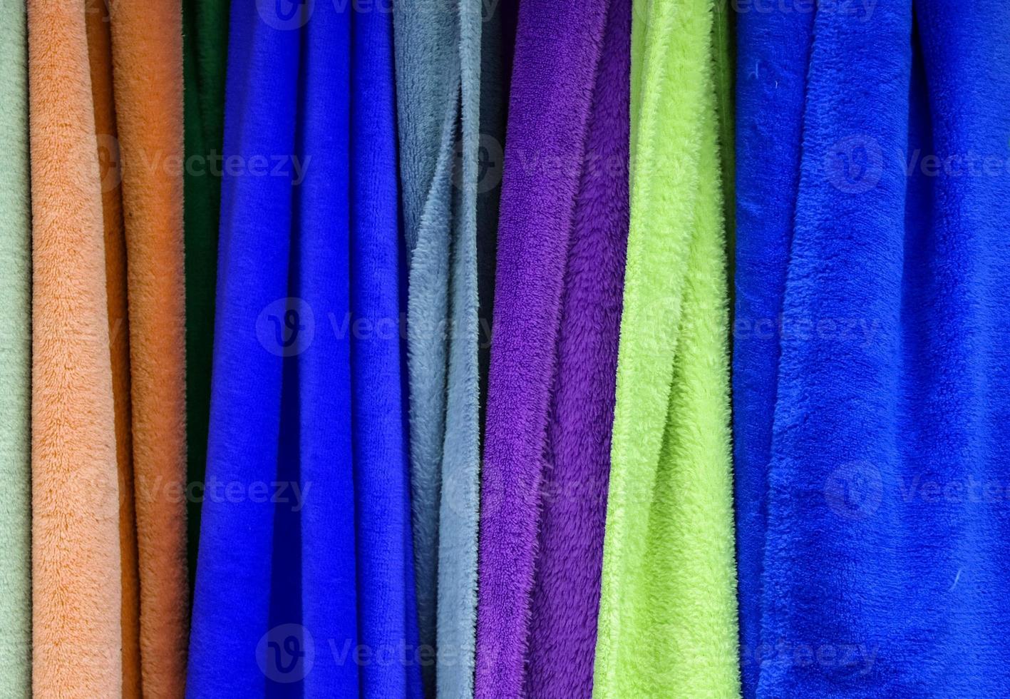 Detailed close up view on samples of cloth and fabrics in different colors found at a fabrics market photo