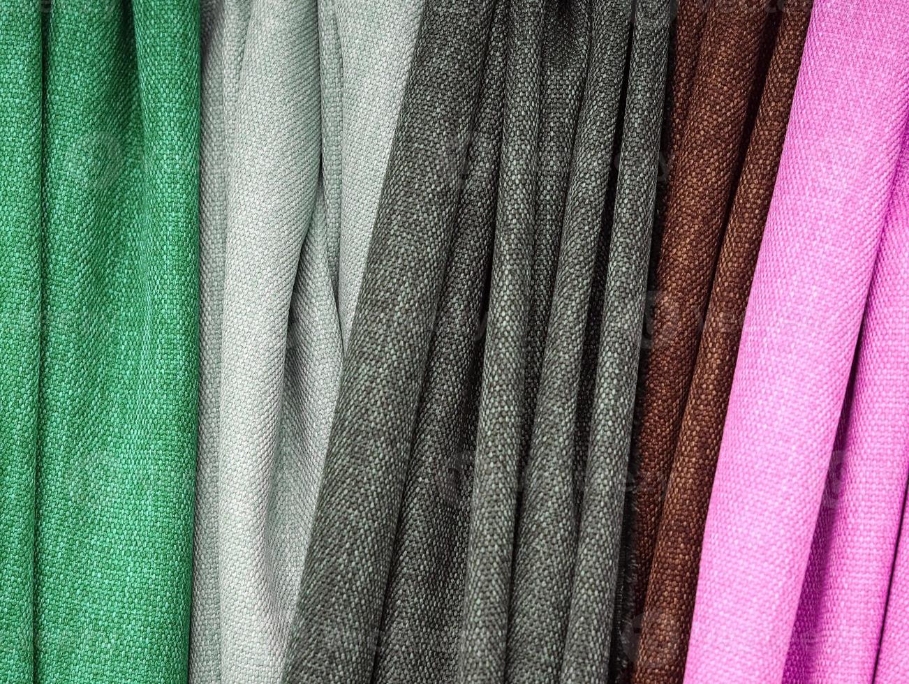 Detailed close up view on samples of cloth and fabrics in different colors found at a fabrics market photo