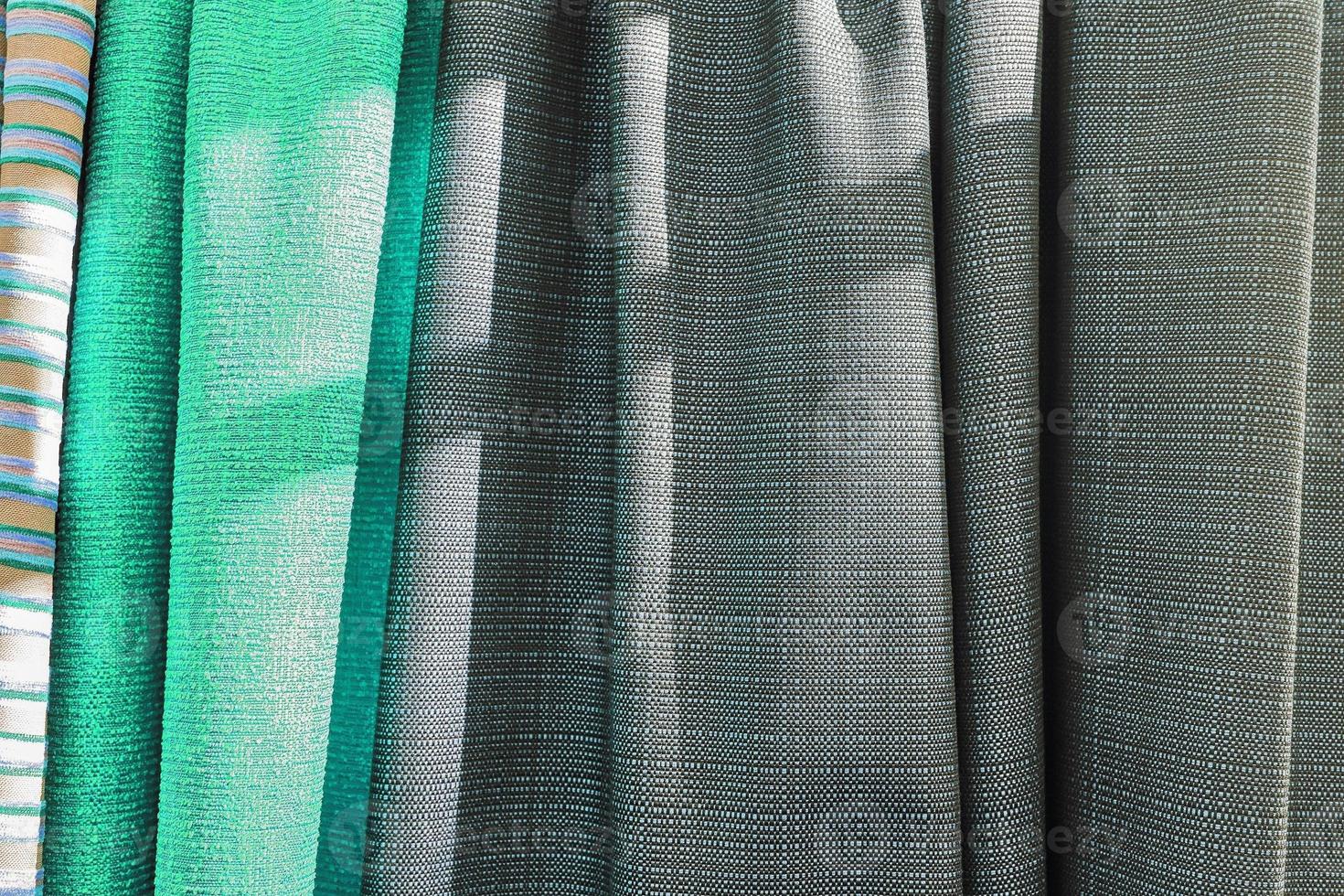 Detailed close up view on samples of cloth and fabrics in different colors found at a fabrics market photo