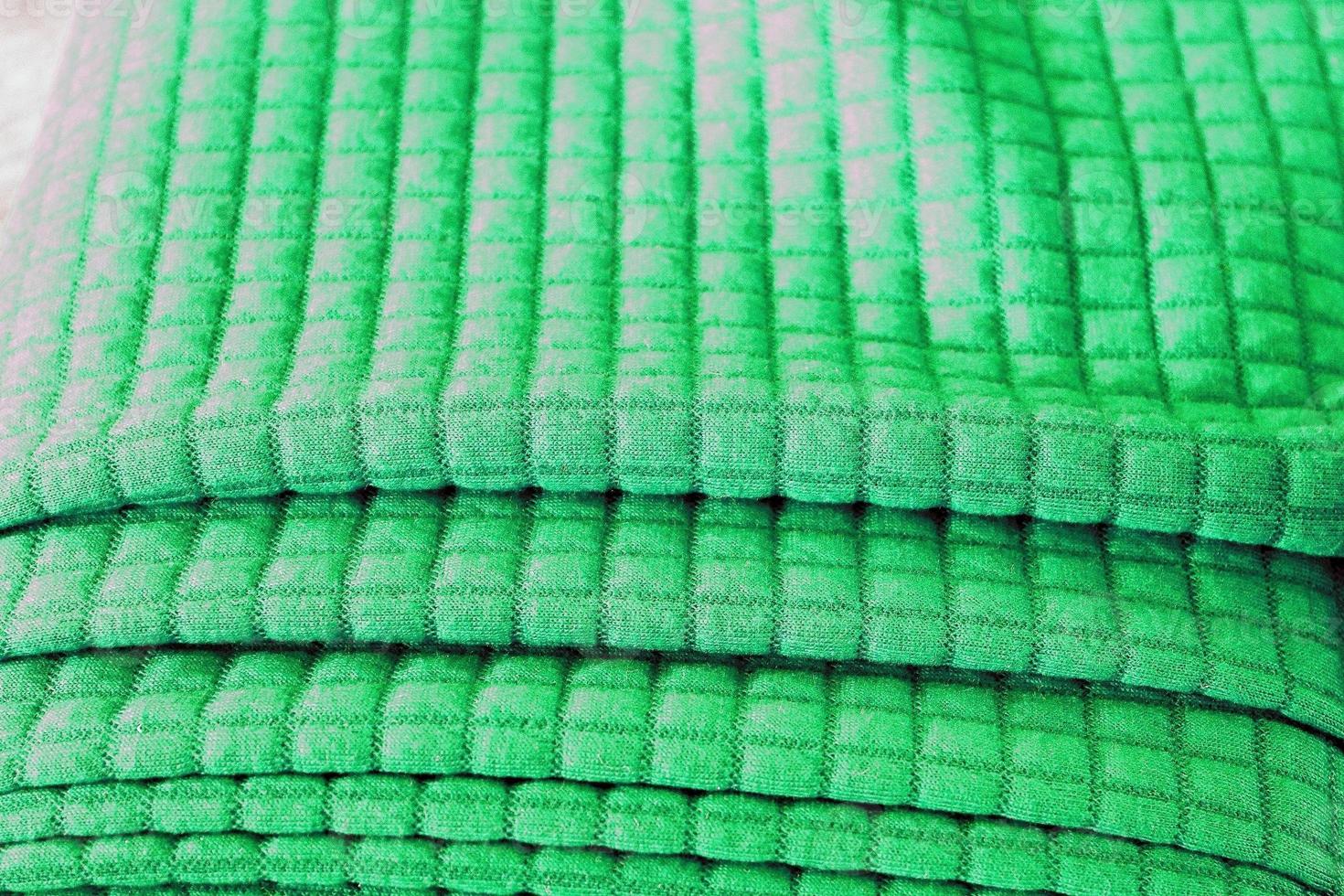 Detailed close up view on samples of cloth and fabrics in different colors found at a fabrics market photo