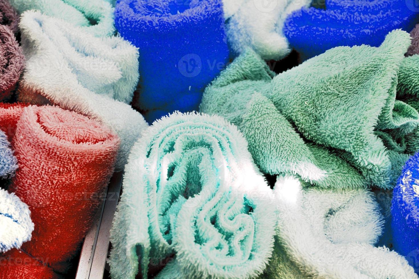 Detailed close up view on samples of cloth and fabrics in different colors found at a fabrics market photo