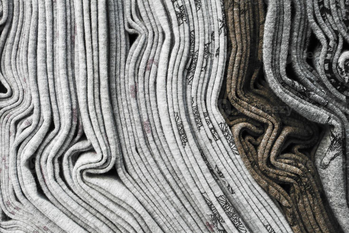Detailed close up view on samples of cloth and fabrics in different colors found at a fabrics market photo