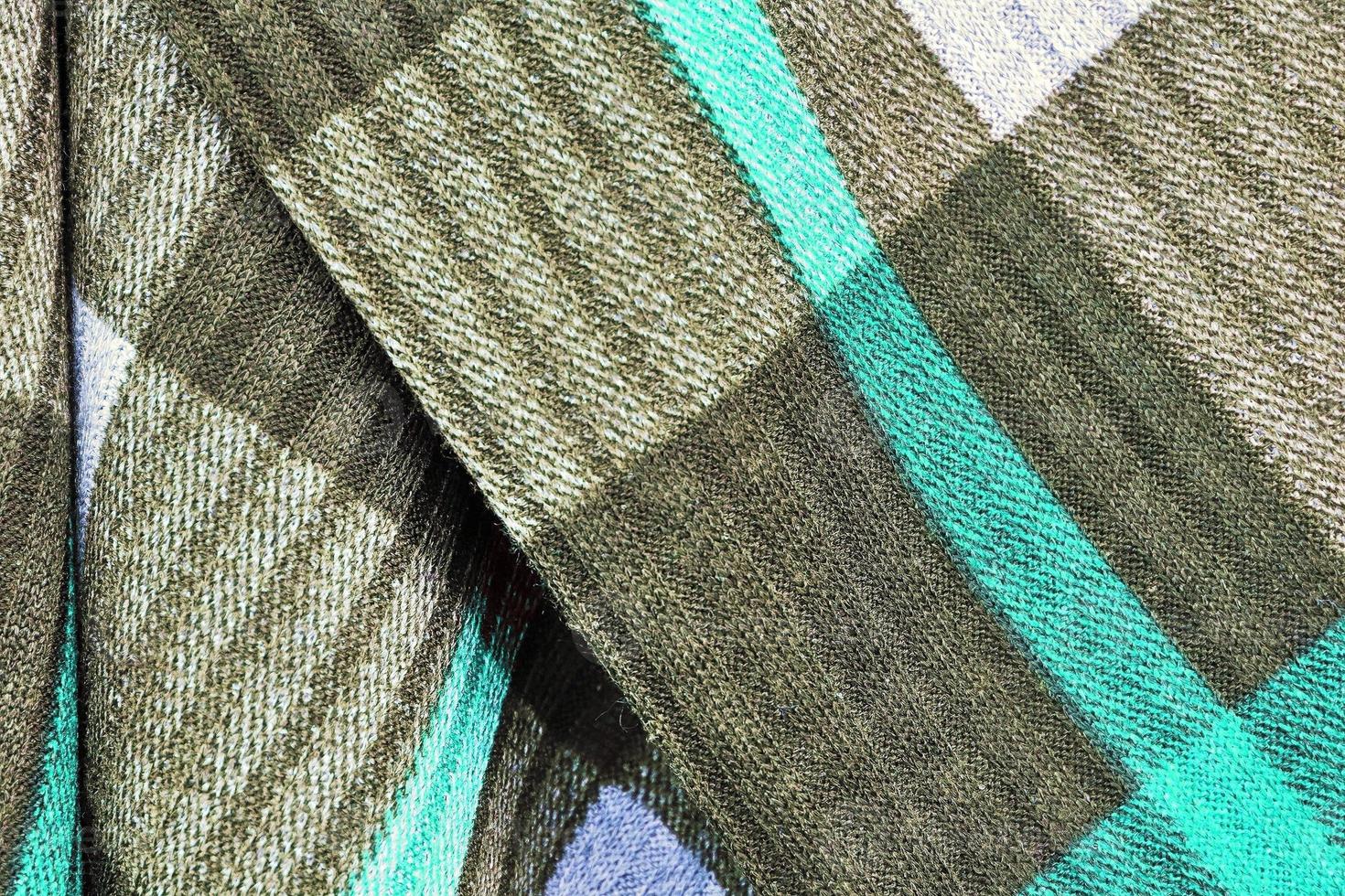Detailed close up view on samples of cloth and fabrics in different colors found at a fabrics market photo