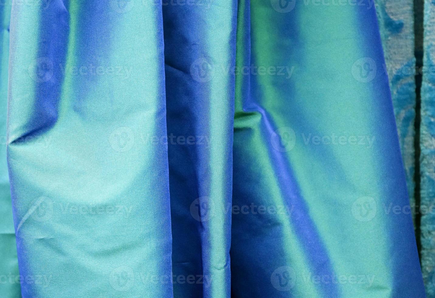 Detailed close up view on samples of cloth and fabrics in different colors found at a fabrics market photo