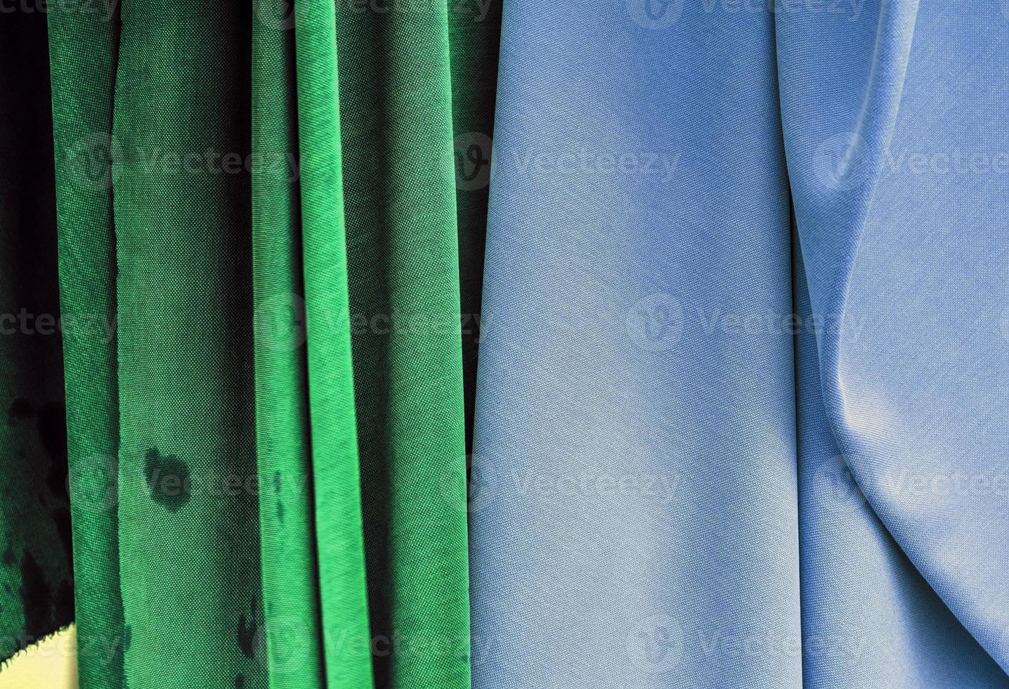 Detailed close up view on samples of cloth and fabrics in different colors found at a fabrics market photo
