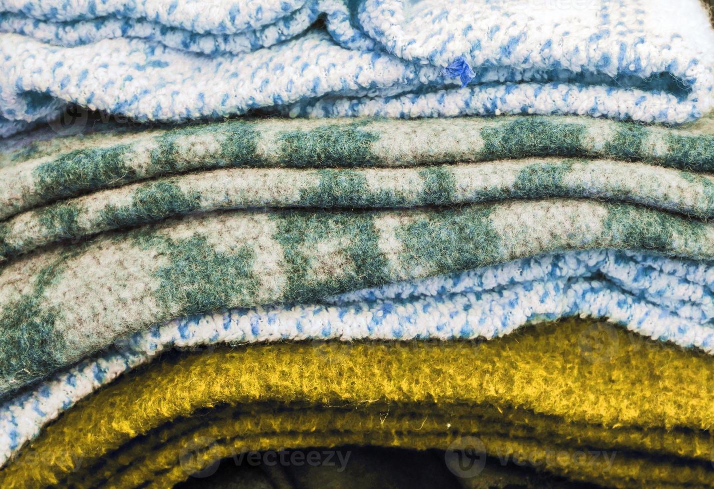 Detailed close up view on samples of cloth and fabrics in different colors found at a fabrics market photo