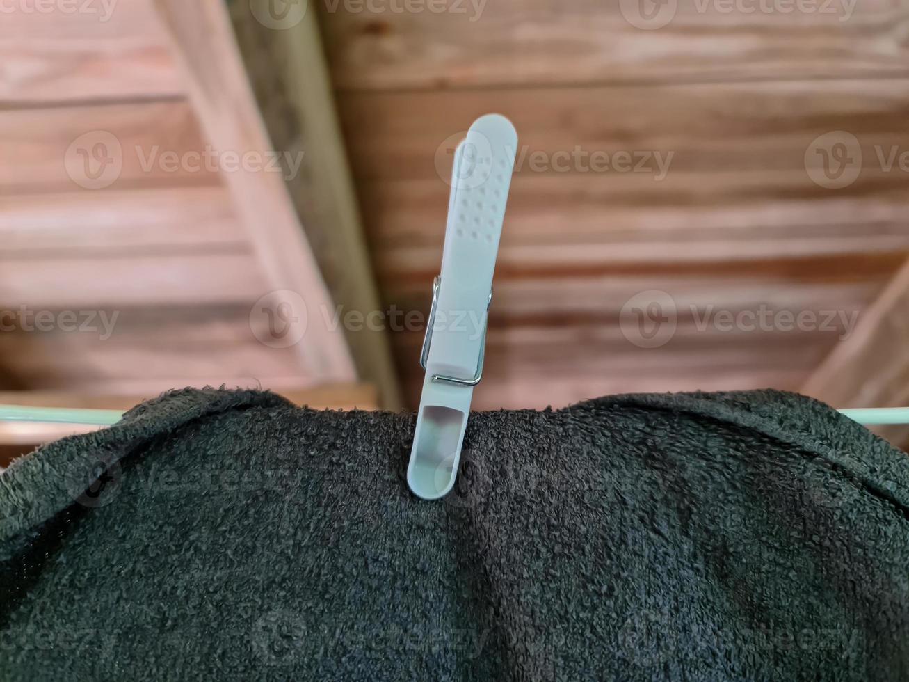 Clothes hung out to dry on a washing line and fastened by the clothes pegs photo