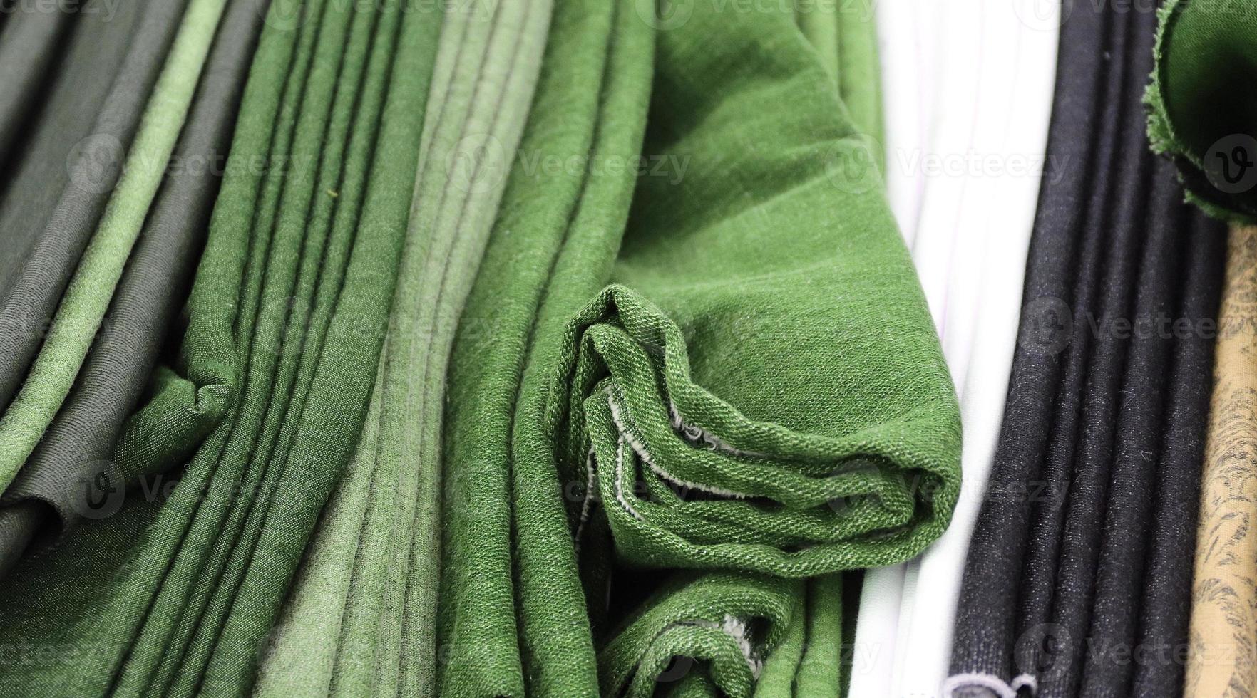 Detailed close up view on samples of cloth and fabrics in different colors found at a fabrics market photo