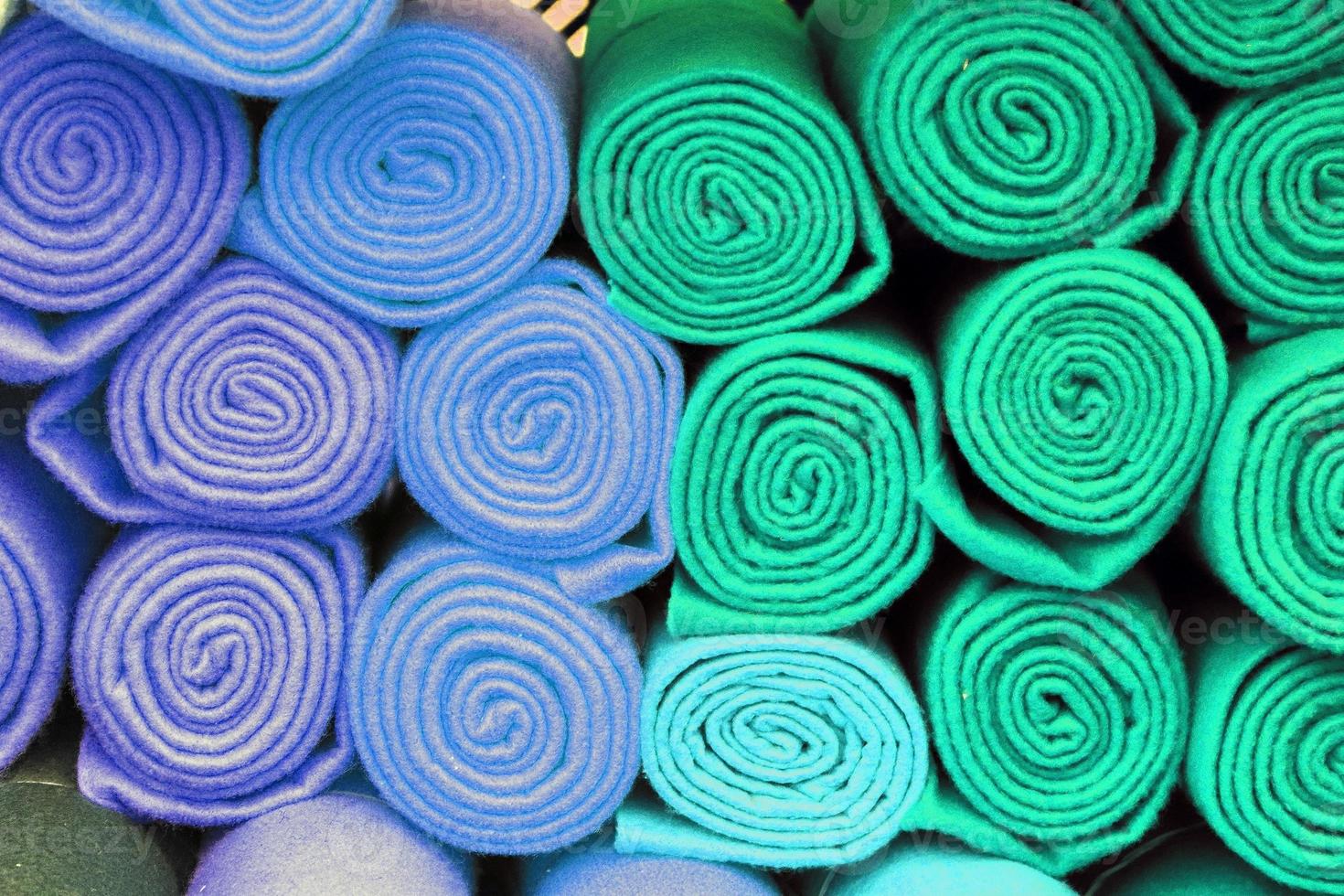 Detailed close up view on samples of cloth and fabrics in different colors found at a fabrics market photo