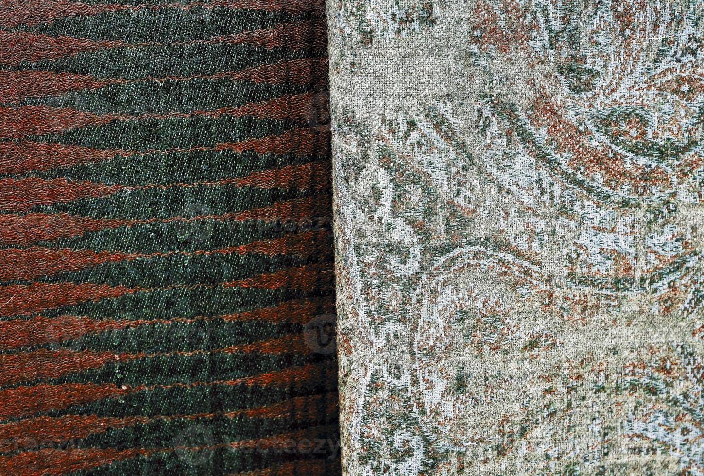 Detailed close up view on samples of cloth and fabrics in different colors found at a fabrics market photo