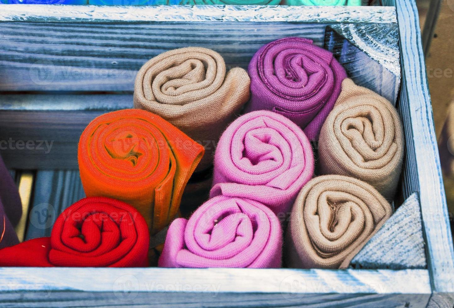 Detailed close up view on samples of cloth and fabrics in different colors found at a fabrics market photo