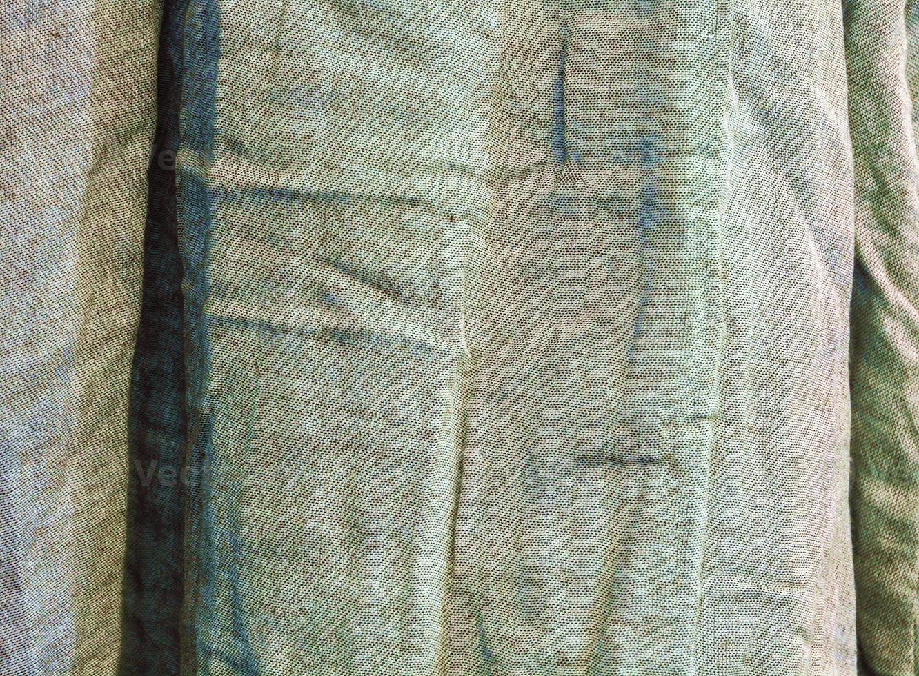 Detailed close up view on samples of cloth and fabrics in different colors found at a fabrics market photo