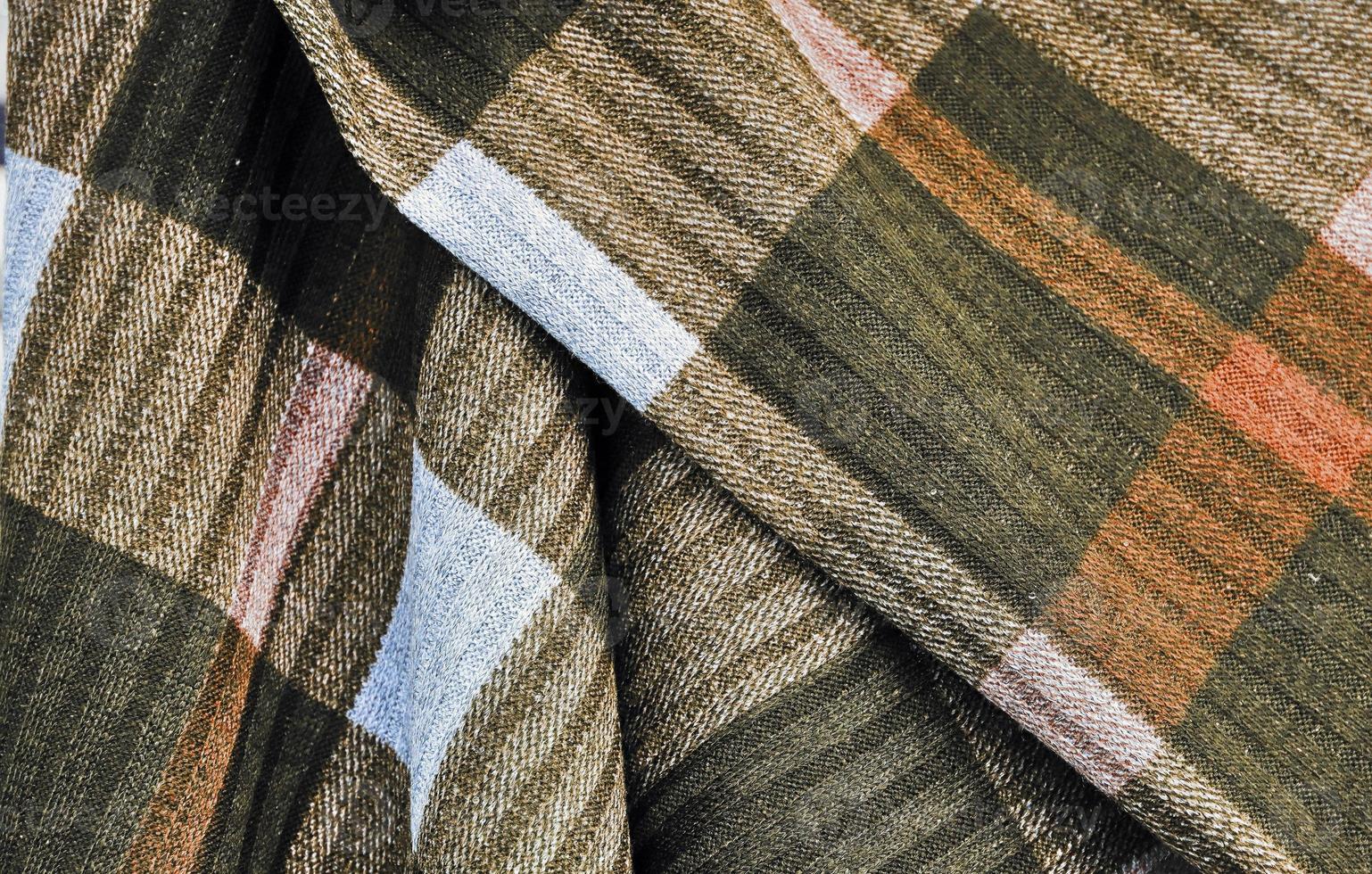 Detailed close up view on samples of cloth and fabrics in different colors found at a fabrics market photo