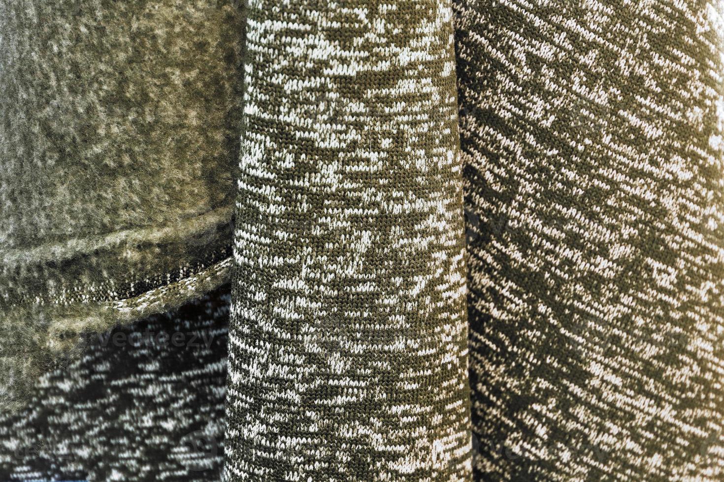 Detailed close up view on samples of cloth and fabrics in different colors found at a fabrics market photo