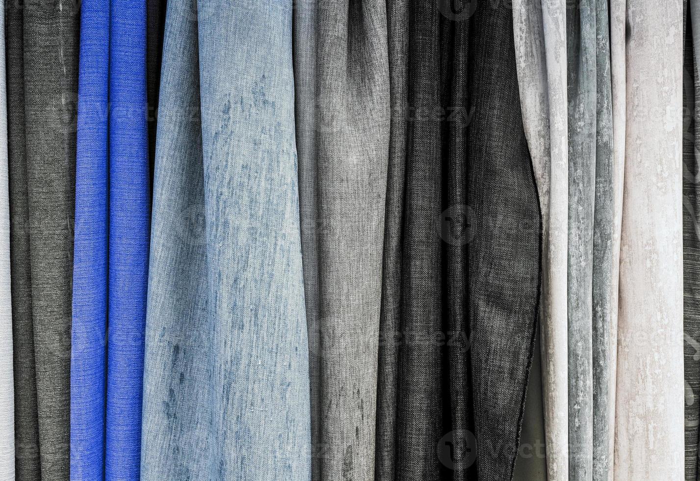 Detailed close up view on samples of cloth and fabrics in different colors found at a fabrics market photo
