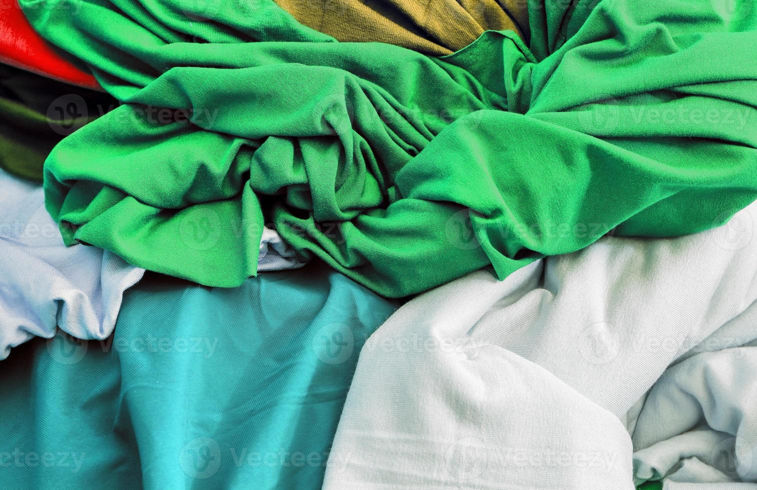 Detailed close up view on samples of cloth and fabrics in different colors found at a fabrics market photo