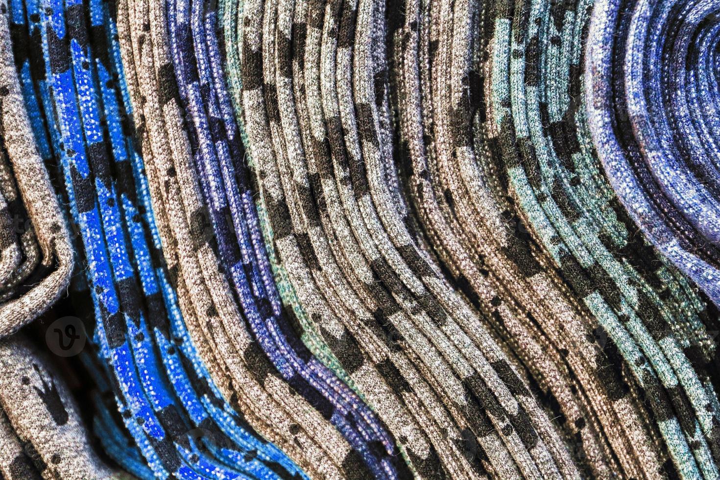 Detailed close up view on samples of cloth and fabrics in different colors found at a fabrics market photo