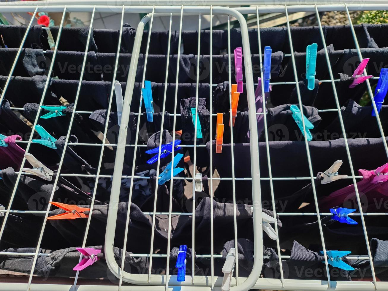 Clothes hung out to dry on a washing line and fastened by the clothes pegs photo