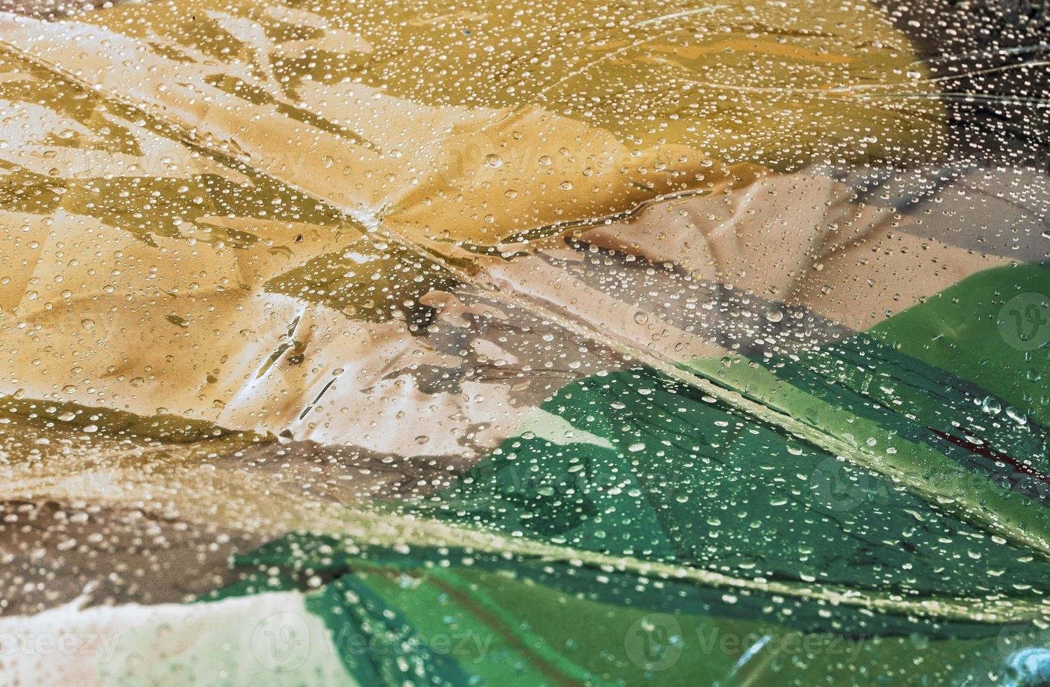 Detailed close up view on samples of cloth and fabrics in different colors found at a fabrics market photo