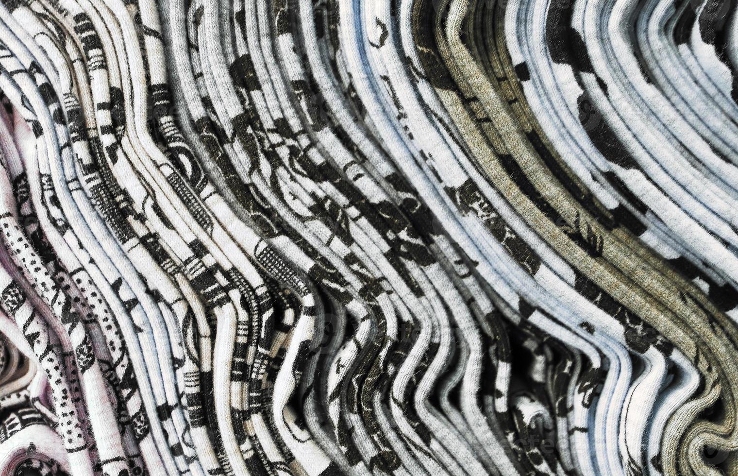 Detailed close up view on samples of cloth and fabrics in different colors found at a fabrics market photo