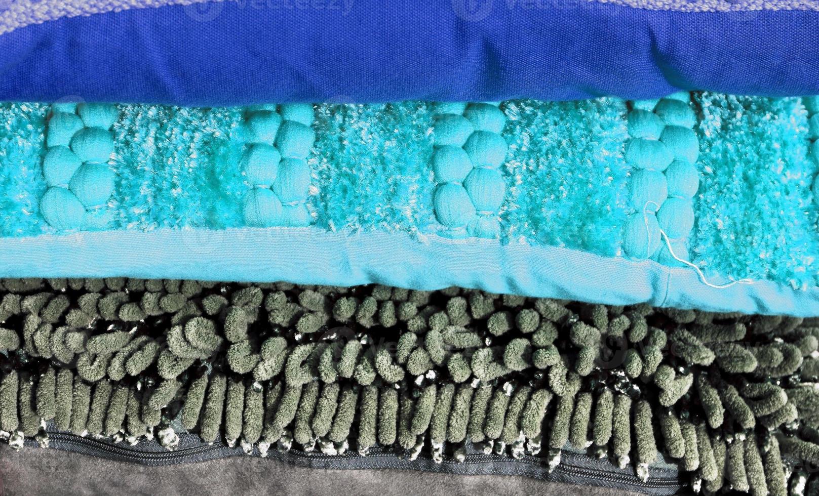 Detailed close up view on samples of cloth and fabrics in different colors found at a fabrics market photo