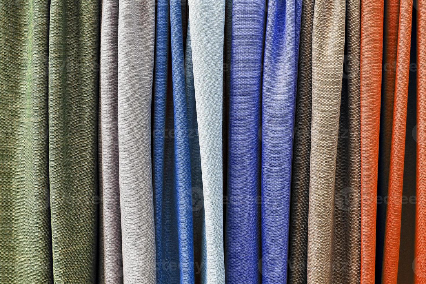Detailed close up view on samples of cloth and fabrics in different colors found at a fabrics market photo