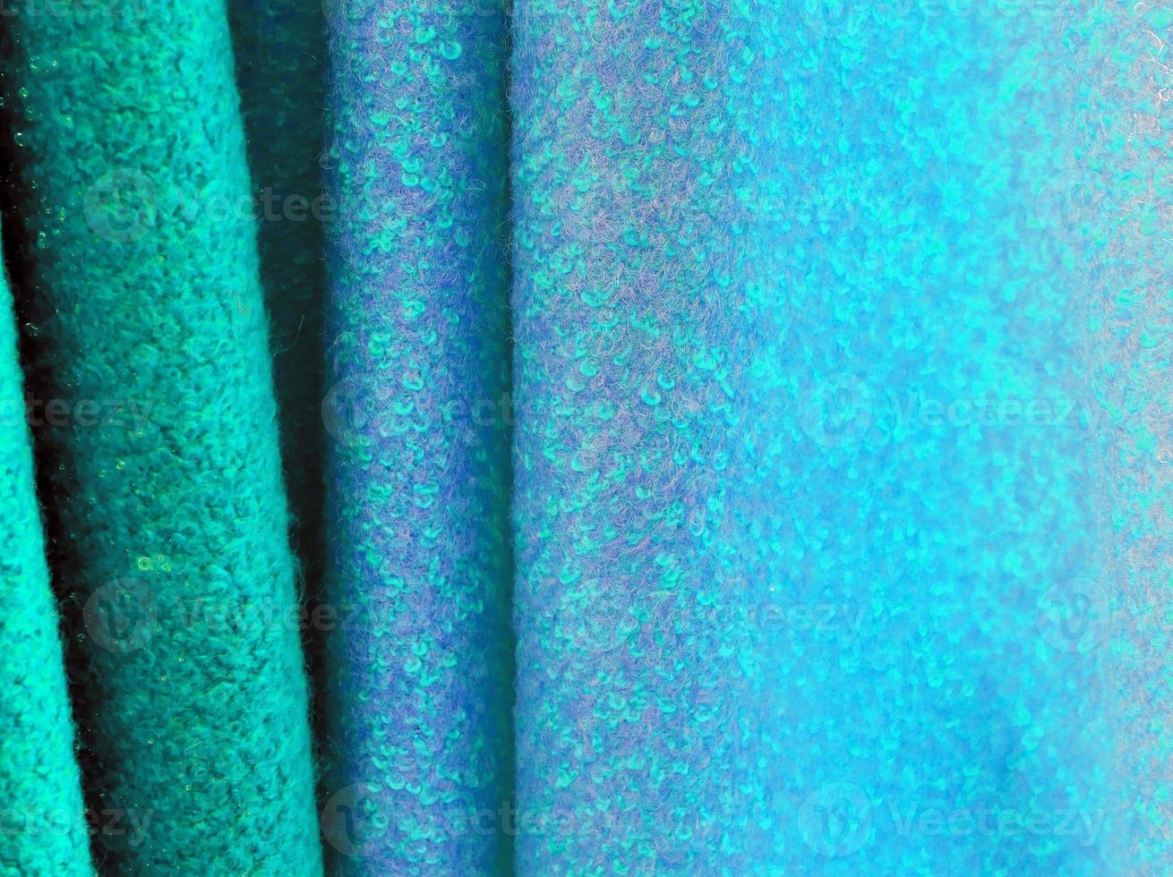 Detailed close up view on samples of cloth and fabrics in different colors found at a fabrics market photo