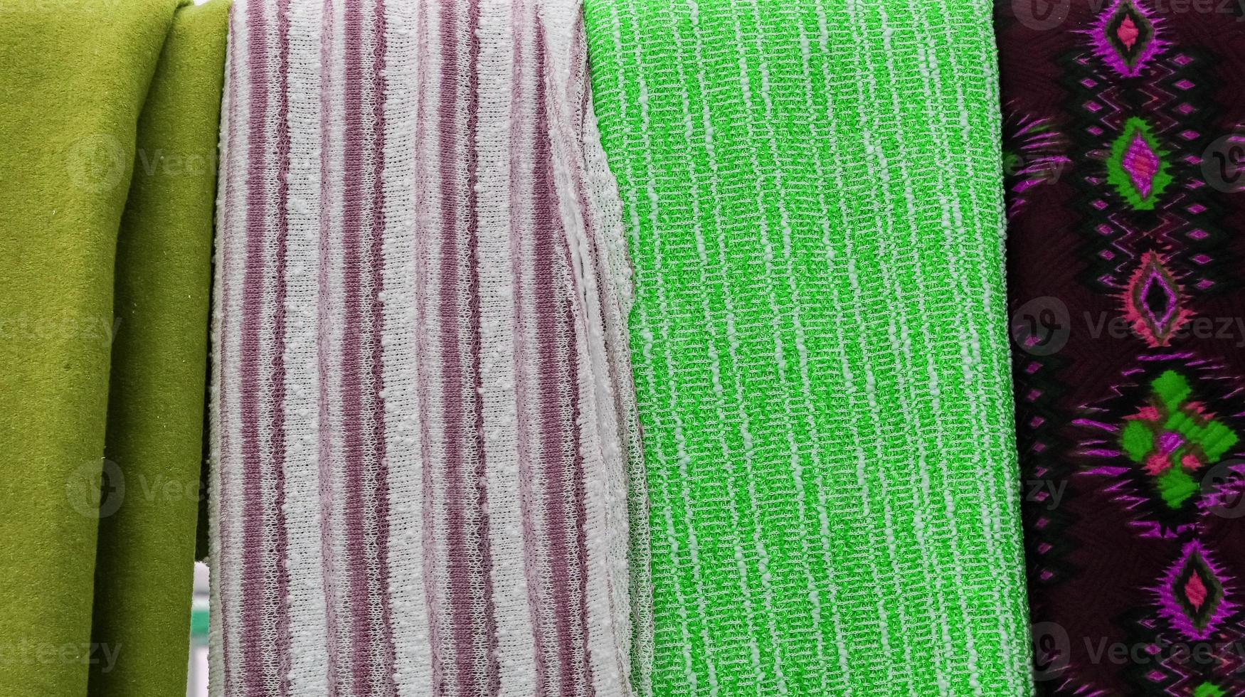 Detailed close up view on samples of cloth and fabrics in different colors found at a fabrics market photo