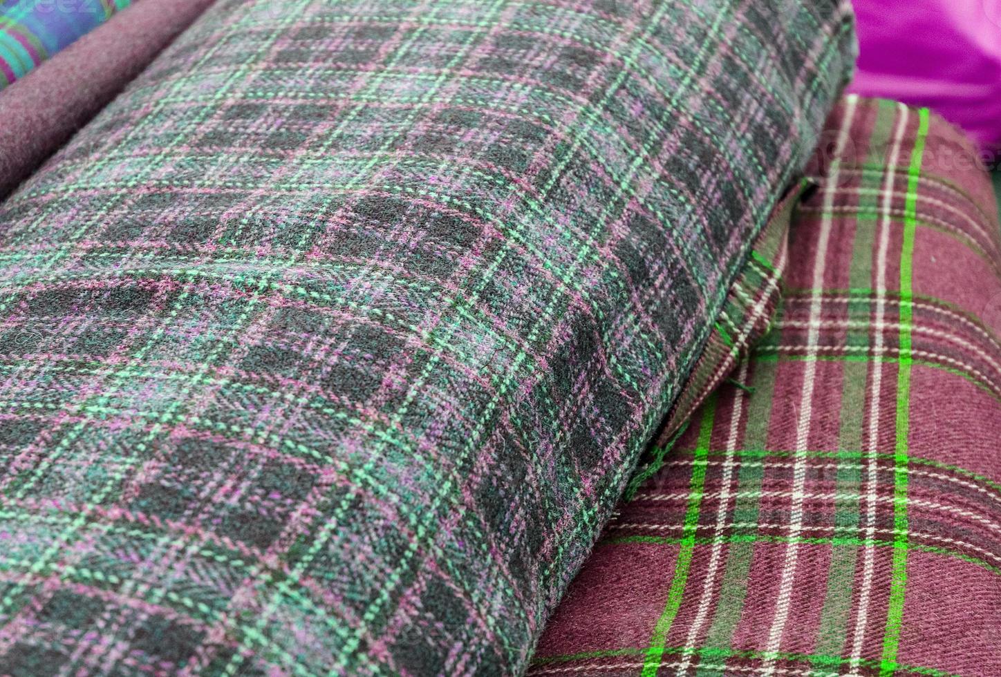 Detailed close up view on samples of cloth and fabrics in different colors found at a fabrics market photo