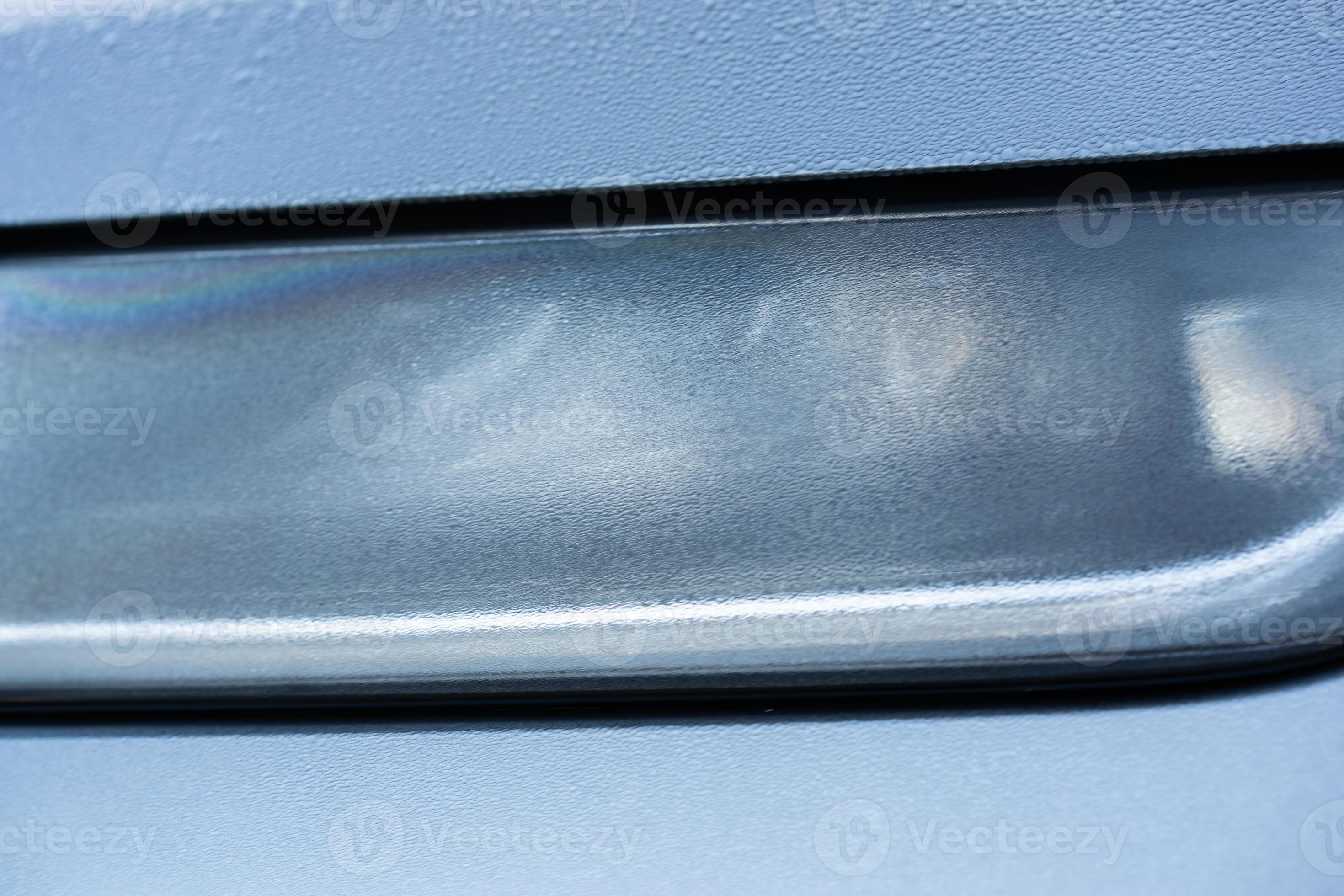 Headlight detail of blue car with water drop after car wash. Close up