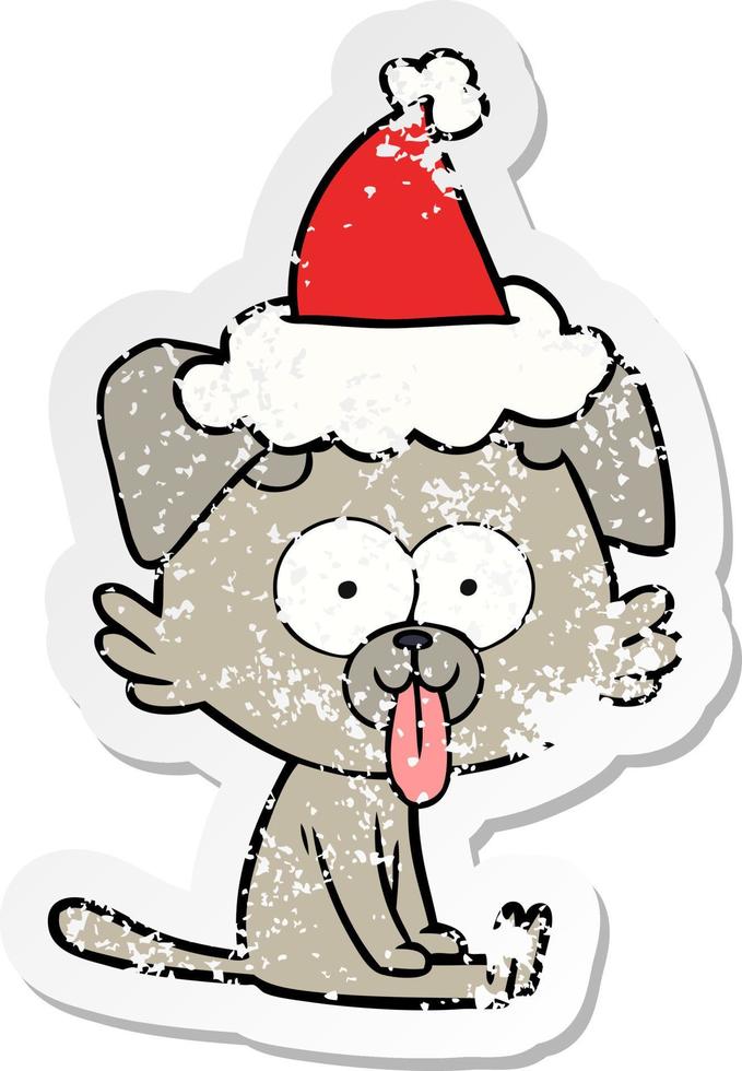 distressed sticker cartoon of a sitting dog with tongue sticking out wearing santa hat vector