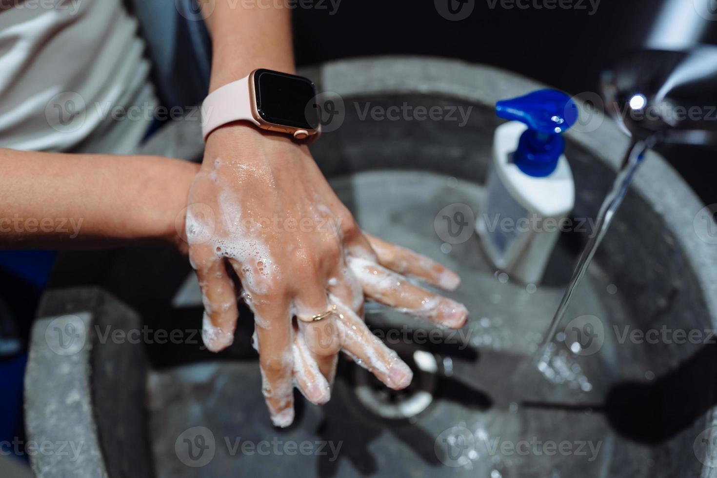 Man washing hands to protect against the coronavirus photo