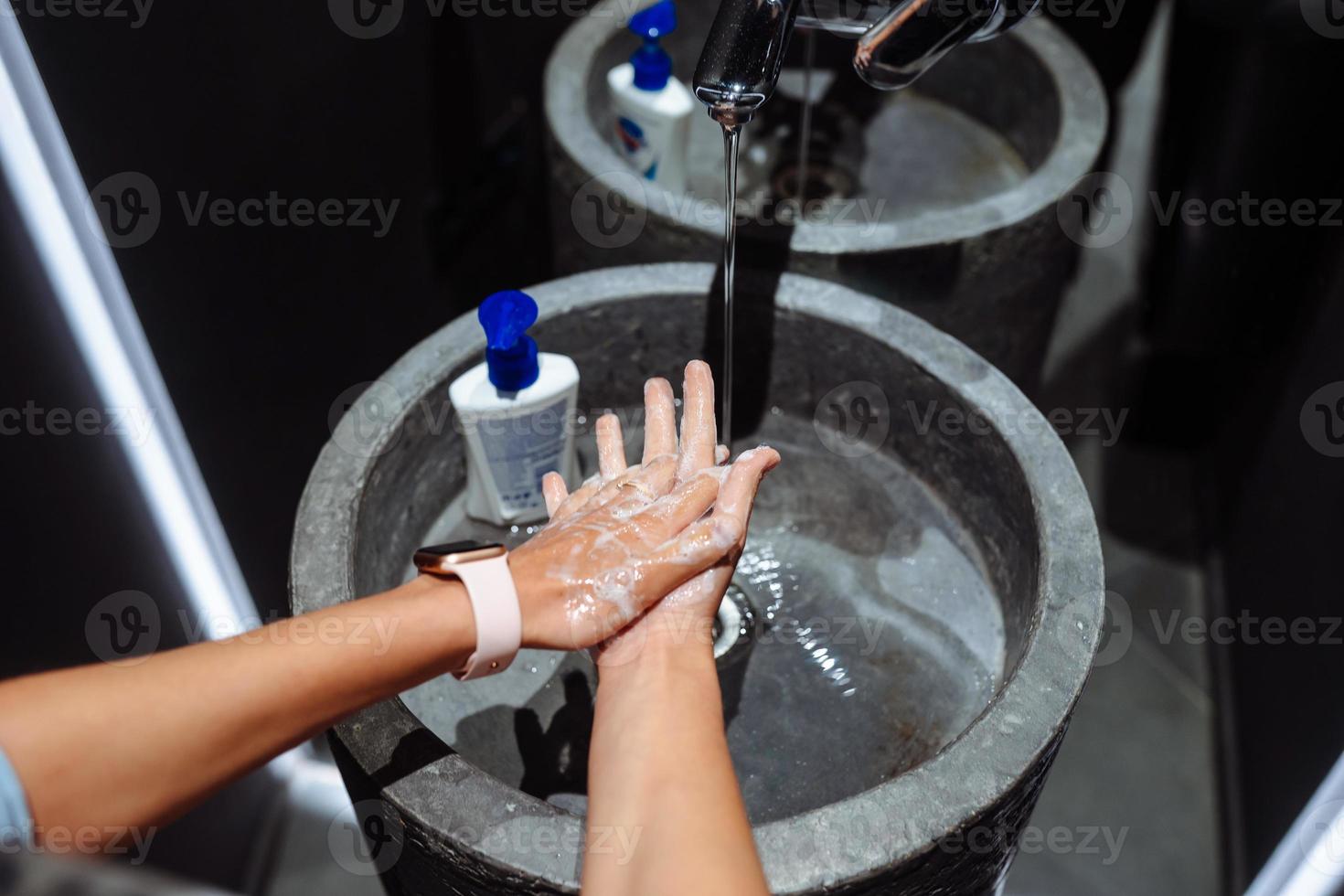 Man washing hands to protect against the coronavirus photo