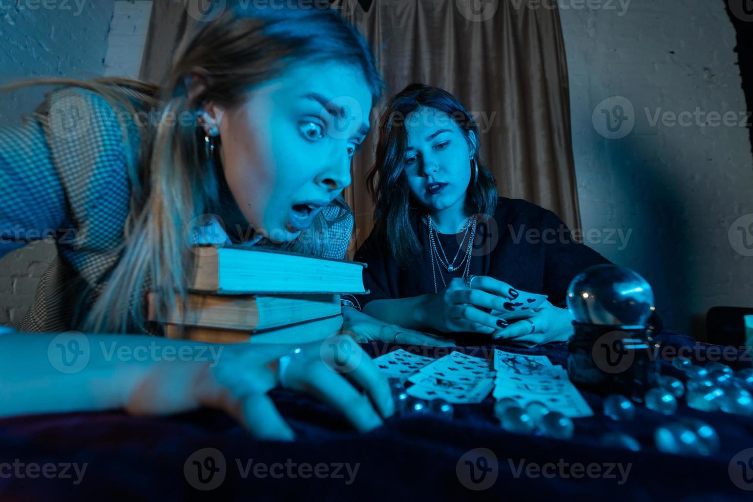 Fortune teller forecasting the future to woman with cards photo