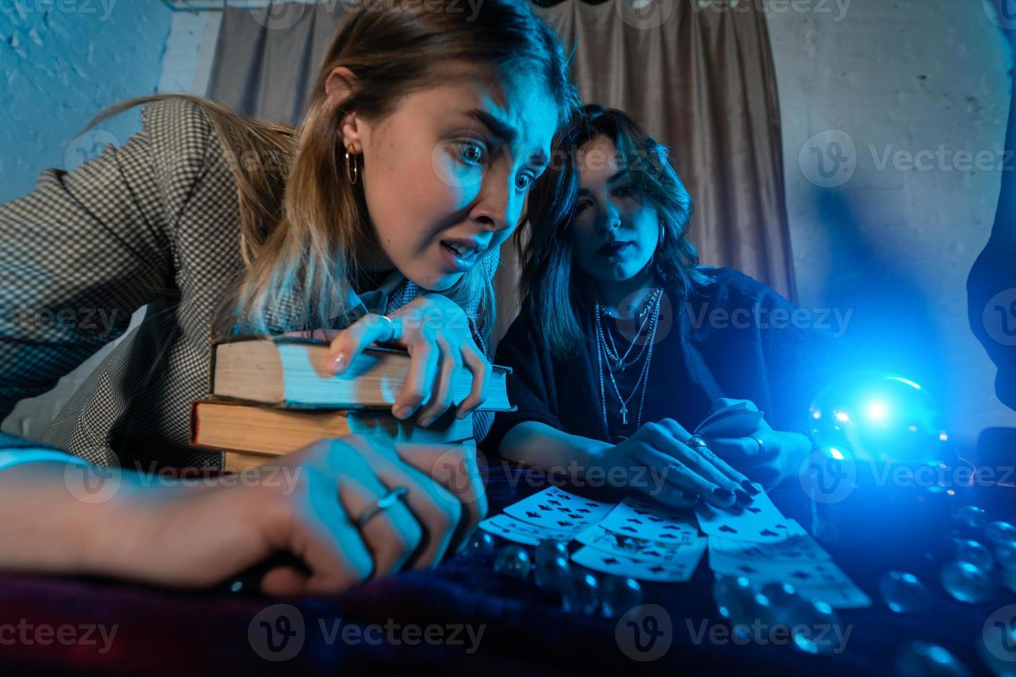 Fortune teller forecasting the future to woman with cards photo