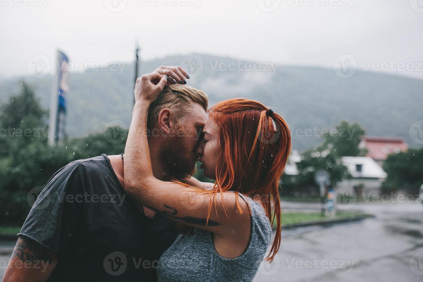 beautiful couple hugging in the rain photo