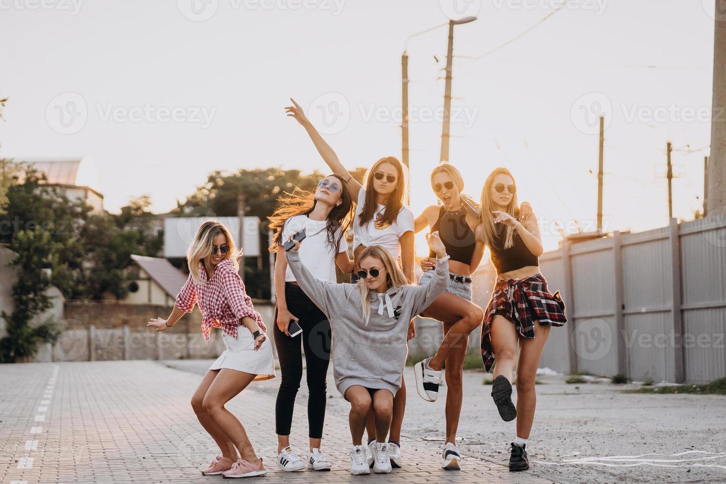 Six young women dance in a car park photo
