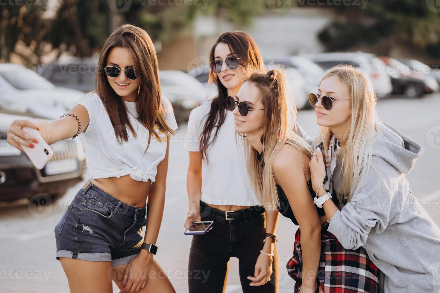 Four young women taking a selfie and have fun photo