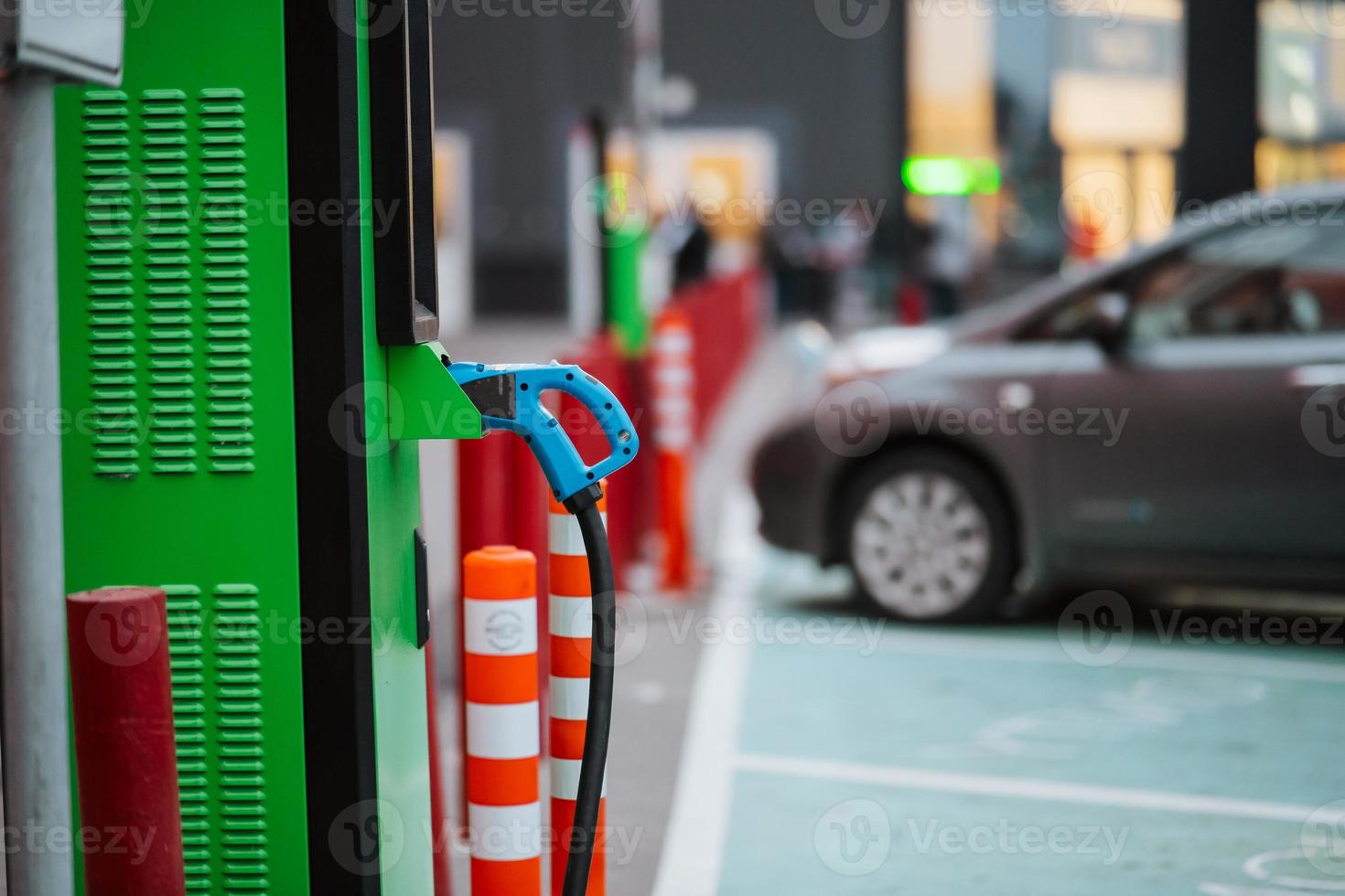 Close up power cord for electric car. Green station photo