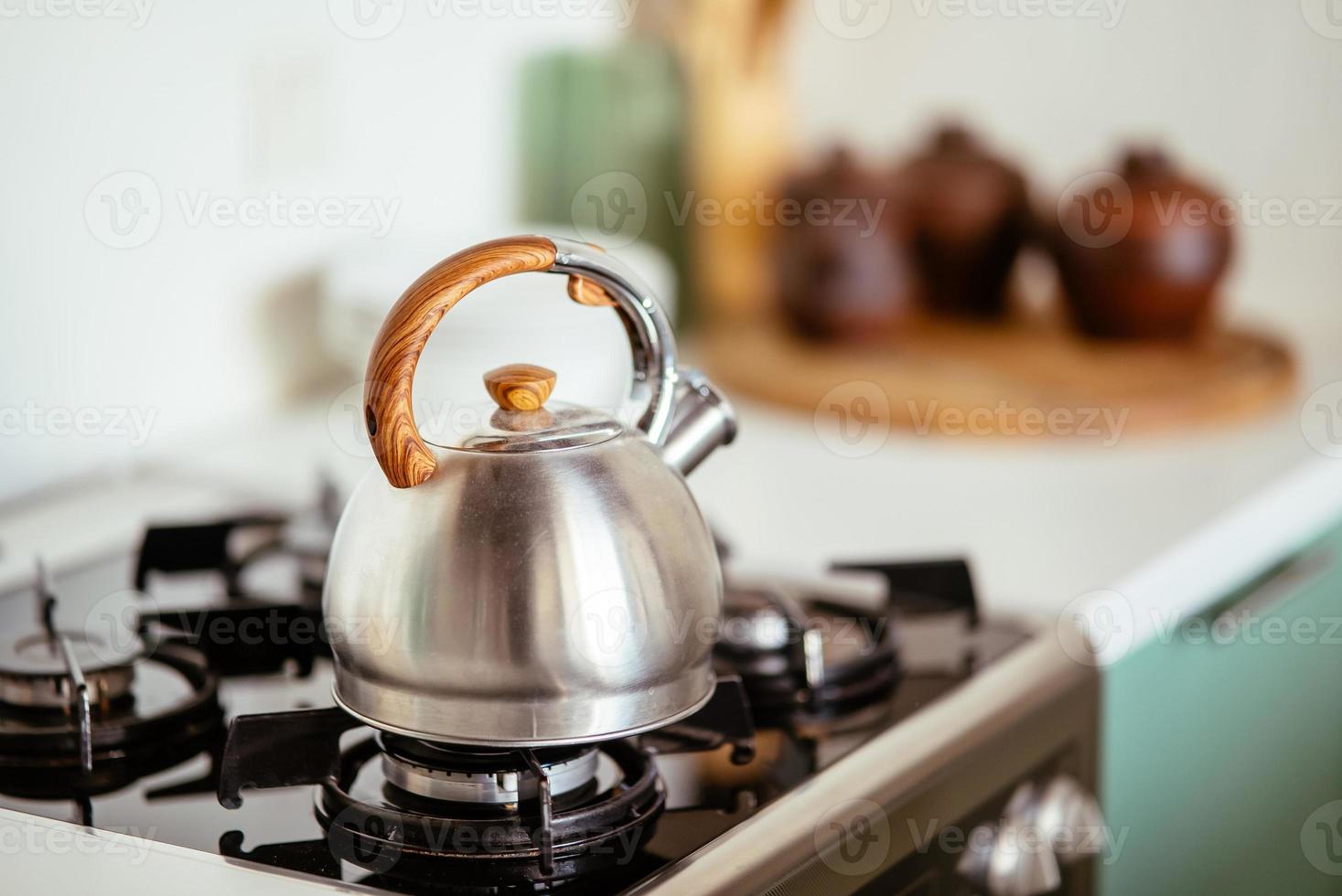 Kettle on the gas stove. Interior of modern kitchen photo
