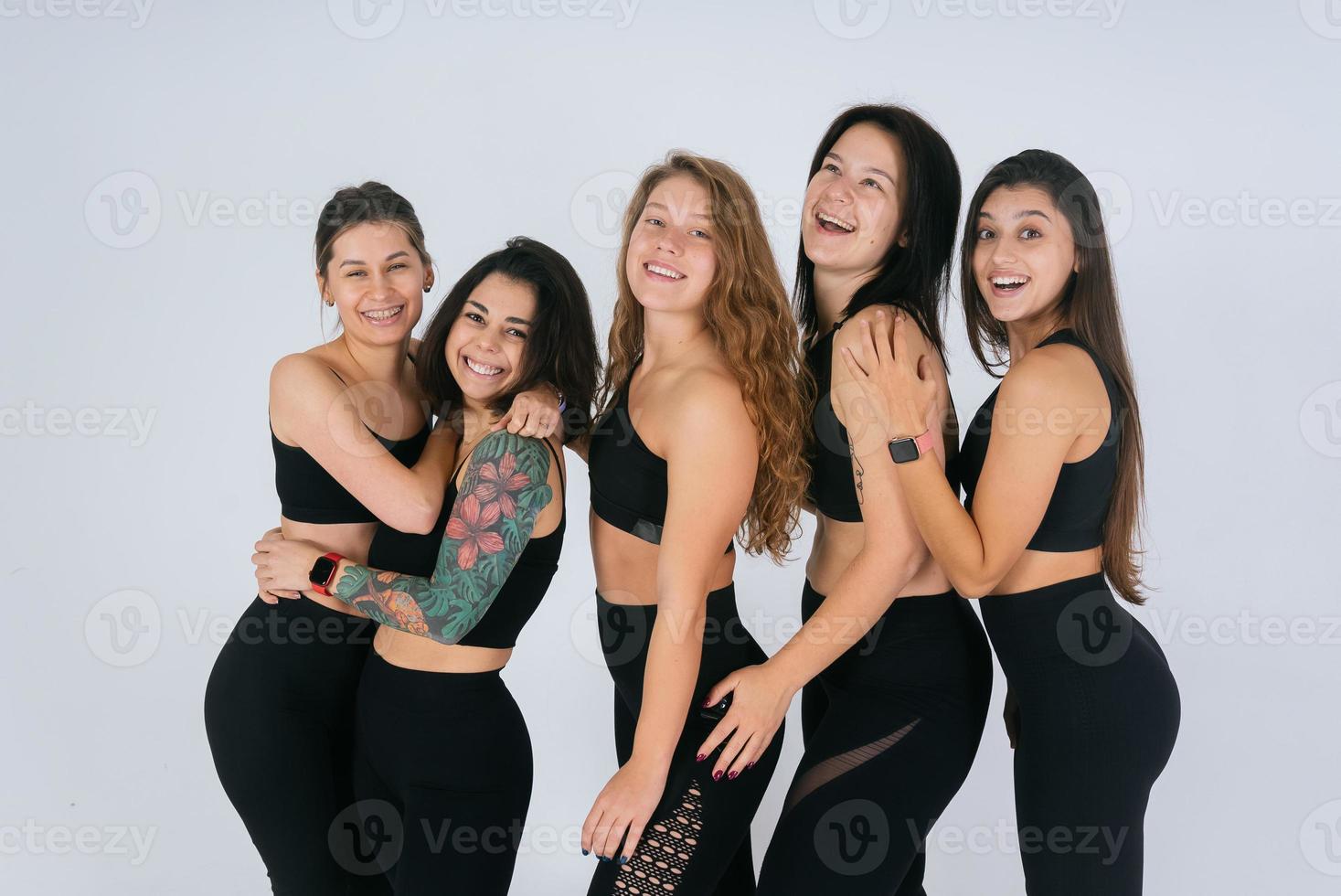 diverse models laughing, enjoying time together, look at camera photo