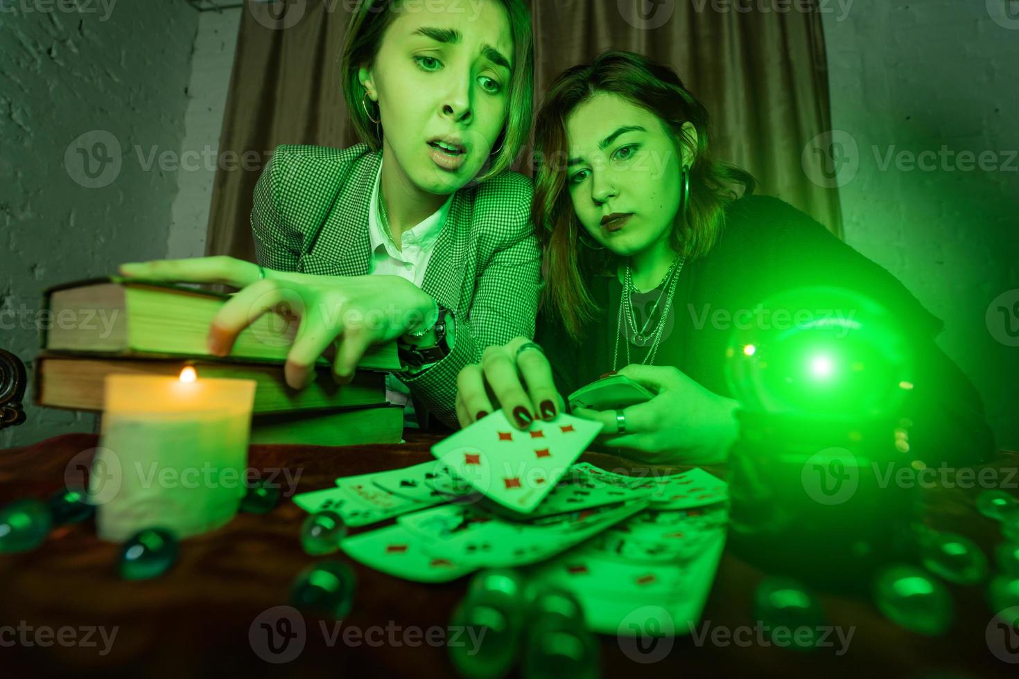 Fortune teller forecasting the future to woman with cards photo
